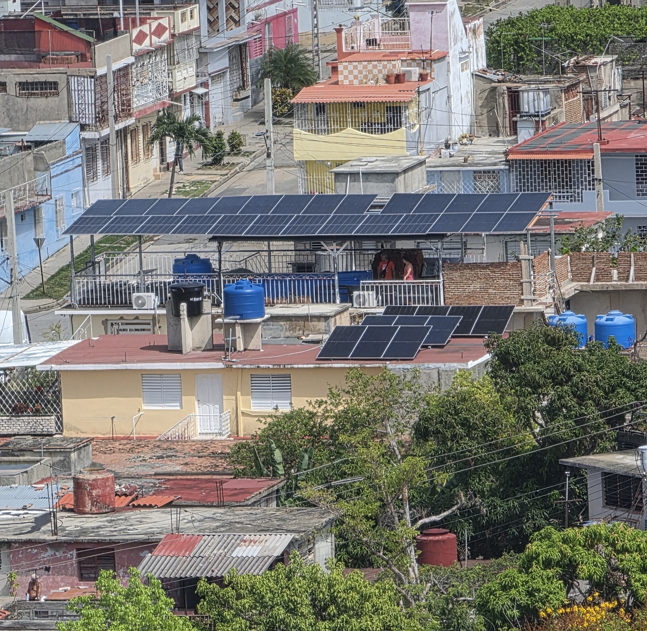 Solar panels installed over residential buildings in Reparto Sueño, Santiago de Cuba, July 2026.